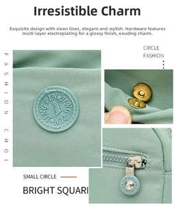 Detail view of mint green fabric texture, metal magnetic clasp and star zipper puller