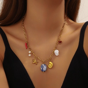 Vintage gold plated necklace with starfish, shell, pearl and ceramic flower charms
