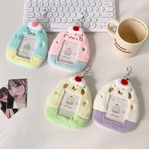 Detail of plush cartoon card holders with cherry charms and transparent display windows