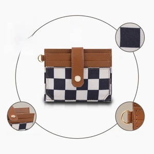 Detail of RFID blocking card holder with checkerboard pattern and gold hardware