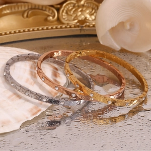 Three-tone stackable 18K gold-plated bracelets with cubic zirconia on white shell