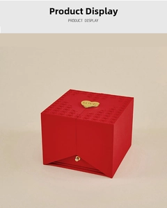 Macro view of red jewelry gift box featuring a gold heart LOVE embossed handle
