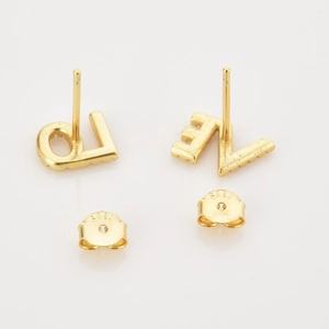 Close-up of S925 sterling silver gold LOVE stud earrings with micro-diamond pavé detailing