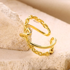Macro detail of gold plated double layer knot ring showing chain texture and V-shape