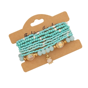Bohemian multi-layer beaded bracelet set with turquoise and white beads on display card
