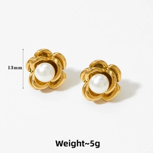 Detail shot of 13mm golden camellia flower stud earrings with white pearl center