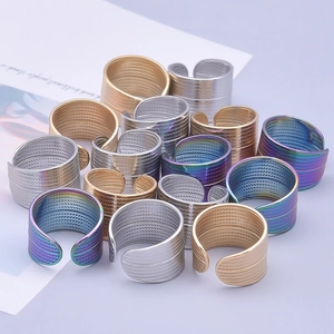 Detailed pile of adjustable geometric 304 steel rings in gold, silver, and rainbow colors