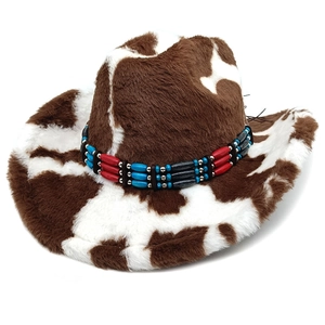 Detail of plush cow print cowboy hat with ethnic beaded band on soft faux fur texture