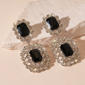 Detail of luxury rectangular black gemstone earrings with sparkling crystal halo finish
