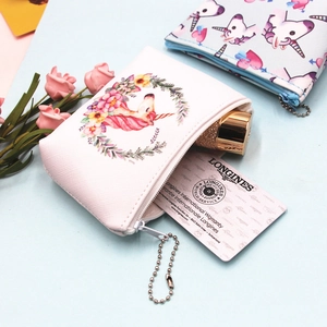 Close-up of cute unicorn coin purses showing internal capacity and floral PU leather texture