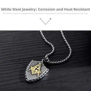 Macro view of stainless steel Masonic shield pendant with golden G compass and square logo