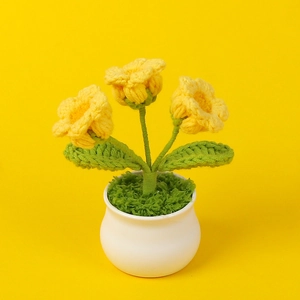 Handmade crochet Lily of the Valley yellow potted plant decor on yellow background