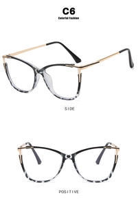 Detail view of cat-eye glasses frames with black marble texture and gold metal temples