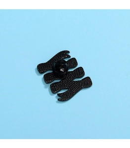 Detail view of the black enamel pin back with secure rubber clutch and textured metal base