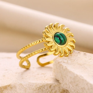 Macro shot of gold double-layer open ring with round green malachite and sunburst details