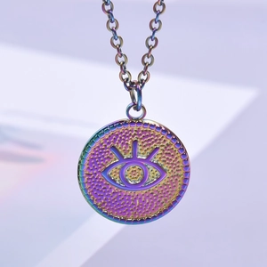 Macro shot of colorful iridescent Devil's Eye pendant with polished stainless steel chain