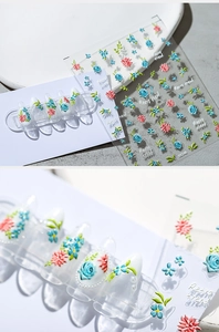 Macro shot of 3D embossed nail stickers featuring blue roses and vintage floral patterns