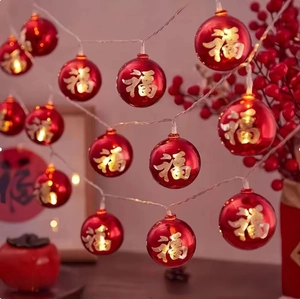 Close-up of LED festive red ball string lights with golden Fu character for New Year