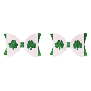 Detail of St. Patrick's Day glitter hair bows featuring green clover patterns and pink accents
