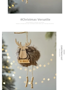 Detail of Christmas reindeer ornament with faux fur and X-MAS wood sign in warm bokeh light