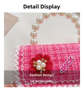 Close-up of pink tweed child handbag with pearl handle, floral decor, and lace edge
