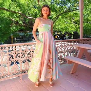 Detail of colorful graffiti print and spaghetti straps on a summer maxi dress