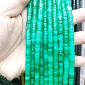 Macro shot of natural green translucent cylindrical spacer beads for DIY jewelry making
