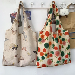 Detail of lightweight canvas tote bags with vintage butterfly and floral prints