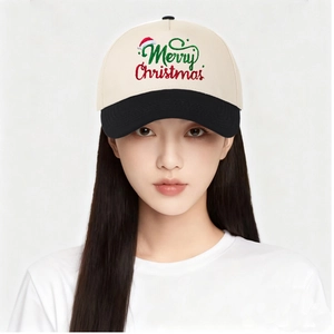 Front view of model wearing a two-tone baseball cap with Merry Christmas embroidery
