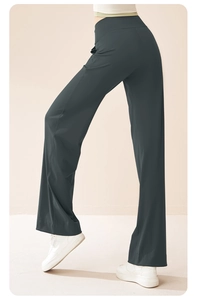 Detail view of high-waisted dark grey yoga pants with flared hem and smooth texture