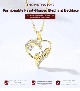 Detail view of S925 sterling silver gold heart pendant with three small elephants and zircons