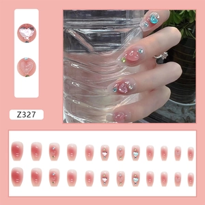 Detail of pink gradient press-on nails with 3D heart gems and rhinestones, set of 24 pieces