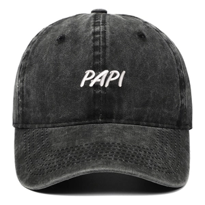 Close-up of 3D white embroidery on a black washed denim baseball cap with PAPI lettering