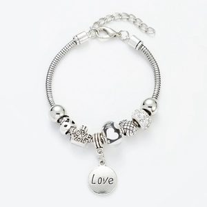Fashionable silver charm bracelet with LOVE pendants and beaded heart elements on snake chain