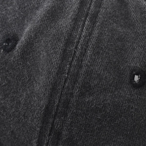 Macro shot of cotton fabric texture and embroidered eyelets on the grey baseball cap