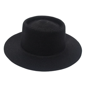 Macro view of horizontal spiral weave texture on black flat-top boater straw hat