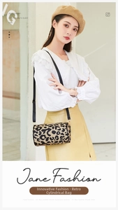 Vintage leopard print cylinder shoulder bag with black leather strap worn by model