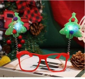 Close-up of LED Christmas tree glasses with festive red frames on a holiday background