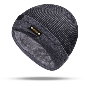 Detail of warm men's winter beanie with thick fleece lining and Sport leather label
