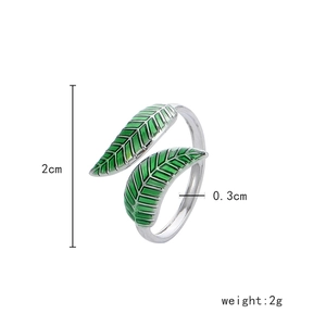 Detailed view of silver adjustable leaf ring with green enamel finish and size specs