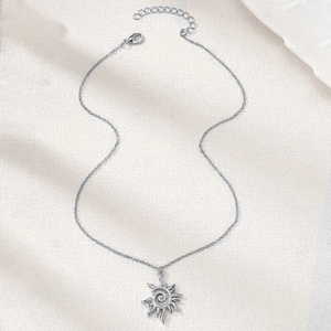 Vintage silver sun vortex pendant necklace with hollow spiral rays on textured background