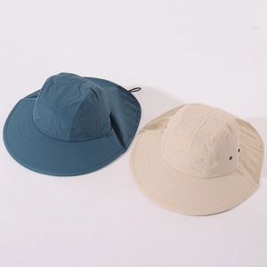 Detail of kids sun hat with neck flap and wide brim in beige and dark teal colors