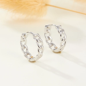 Macro view of S925 sterling silver chain link hoop earrings with floral decor