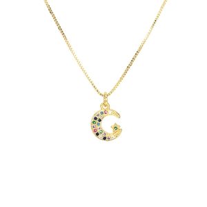 Exotic gold necklace featuring a celestial moon and star pendant with colorful crystals