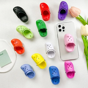 Mini clog-shaped phone socket grips in vibrant colors for desktop support