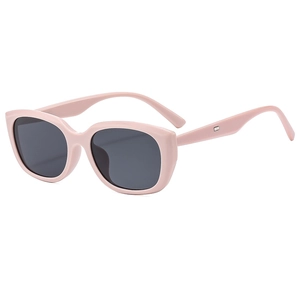 Retro pink cat-eye sunglasses with grey lenses, 45-degree angle view on white background
