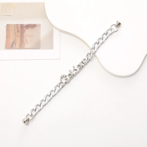 Silver double chain bracelet with Golden engraved bar and magnetic closure on white backdrop