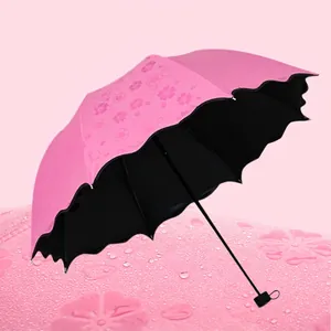 Pink folding umbrella with magic floral pattern and black vinyl sun protection coating