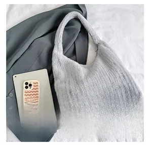 Detail of light gray faux fur tote bag showing plush texture and spacious interior capacity