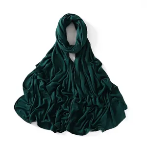 Detail of dark green cotton jersey scarf showing fabric texture and overlocked edge
